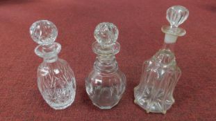 Three antique cut glass decanters. One Victorian 'Newcastle bell' blown glass decanter with