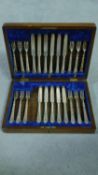 A Victorian oak cased canteen of silver plate cutlery by Levesley Brothers of Sheffield. Scrolling