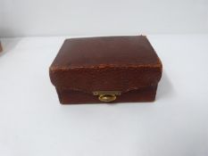 A collection of antique and vintage jewellery in a leather look and brass jewellery chest. Including