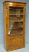 A mid 19th Century burr walnut bookcase with glazed and panelled door enclosing fitted bookshelves