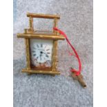 Antique enamel gilt carriage clock, with enamel painted panels with cherubs catching butterflies.