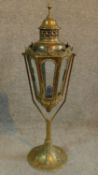 A swinging antique brass arts and crafts table lamp/candle holder with intricate brass detailing and