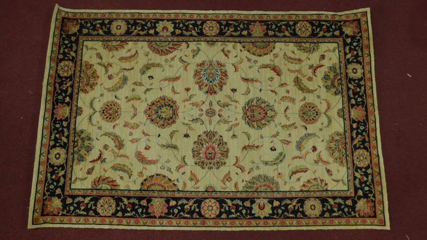 A Kashan style rug, all over spandrel motifs with repeating petal motifs on an ivory field,