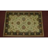 A Kashan style rug, all over spandrel motifs with repeating petal motifs on an ivory field,