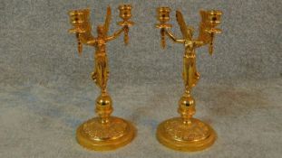 A pair of empire style gilded lady victory candle sticks. Each with two branches. H.28cm