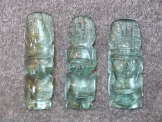 A trio of vintage carved Mexican aqua art glass Aztec heads. Graduating in size. Tallest 18.5cm.