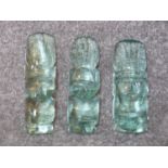 A trio of vintage carved Mexican aqua art glass Aztec heads. Graduating in size. Tallest 18.5cm.