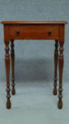 A late 19th Century mahogany bedside table with frieze drawer, raised on turned tapering supports.