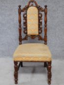A Victorian oak chair with floral carving to the back and woven peacock feather design upholstery