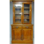 A Victorian oak library bookcase, the upper glazed section above panelled doors on plinth base. H.