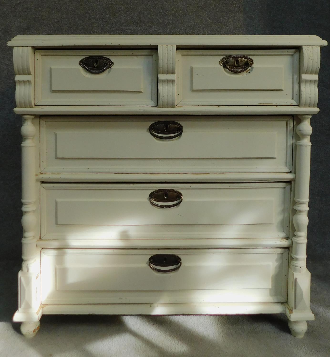 A 19th century Continental painted chest of two short over three long drawers flanked by turned