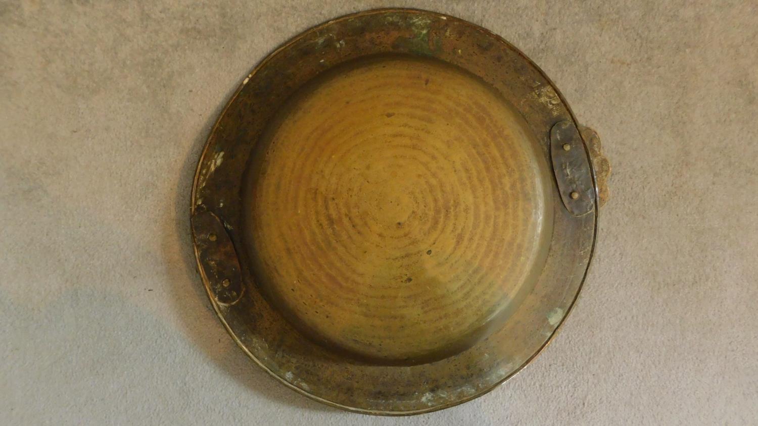 A large Oriental vintage beaten brass bowl with pair of swing handles. 65x65cm - Image 4 of 6