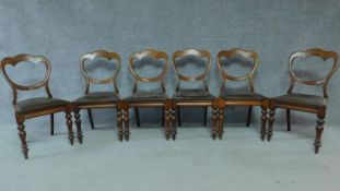 A set of six mid Victorian mahogany shaped back dining chairs raised on bulbous turned supports.