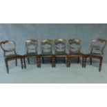 A set of six mid Victorian mahogany shaped back dining chairs raised on bulbous turned supports.