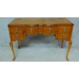 An early Georgian style burr walnut desk on shell carved cabriole supports. H.77 W.113 D.56cm