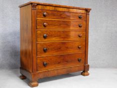 An early Victorian mahogany chest of five long drawers, top drawer fitted with secret compartment.