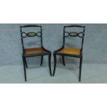 A pair of Regency ebonised caned seated chairs with rope twist top rails and brass eagle motifs,