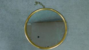 A circular giltwood framed wall mirror. 66x66cm