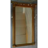 A Regency gilt pier mirror fitted with original bevelled plate flanked by fluted classical