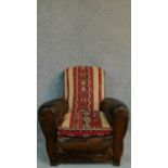 A mid 20th Century leather armchair with kelim covered back and seat. H.88cm