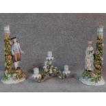 A pair of antique hand painted and gilded German porcelain Sitzendorf figural candle sticks with