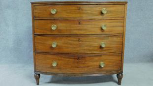 A Regency mahogany bow fronted chest of four long drawers with solid mahogany drawer linings,