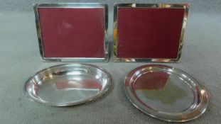 A pair of circular EPNS trays and a pair of silver plated rectangular Richard Carr photo frames.