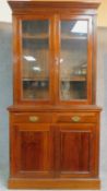 A late 19th century walnut library bookcase with glazed upper section above pair of frieze drawers