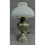 A vintage oil lamp with original milk glass shade. H.44cm