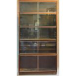 A Mid 20th century mahogany five section bookcase fitted sliding doors on plinth base, by Minty.