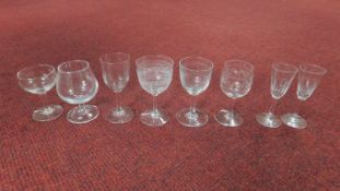 Eight engraved Victorian stemmed drinking glasses. A pair of port glasses with oval faceted