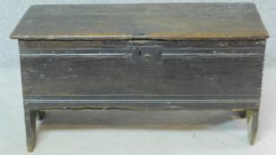 An antique oak plank coffer with hinged lid and feet carved to the side. H.48 W.91 D.38cm