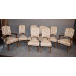 A set of eight Continental Art Deco bird's eye walnut dining chairs in floral damask upholstery on