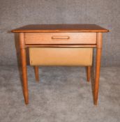 A 1970's vintage teak work table fitted slide out sewing basket on tapering supports. H.50 x 57cm