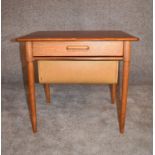 A 1970's vintage teak work table fitted slide out sewing basket on tapering supports. H.50 x 57cm