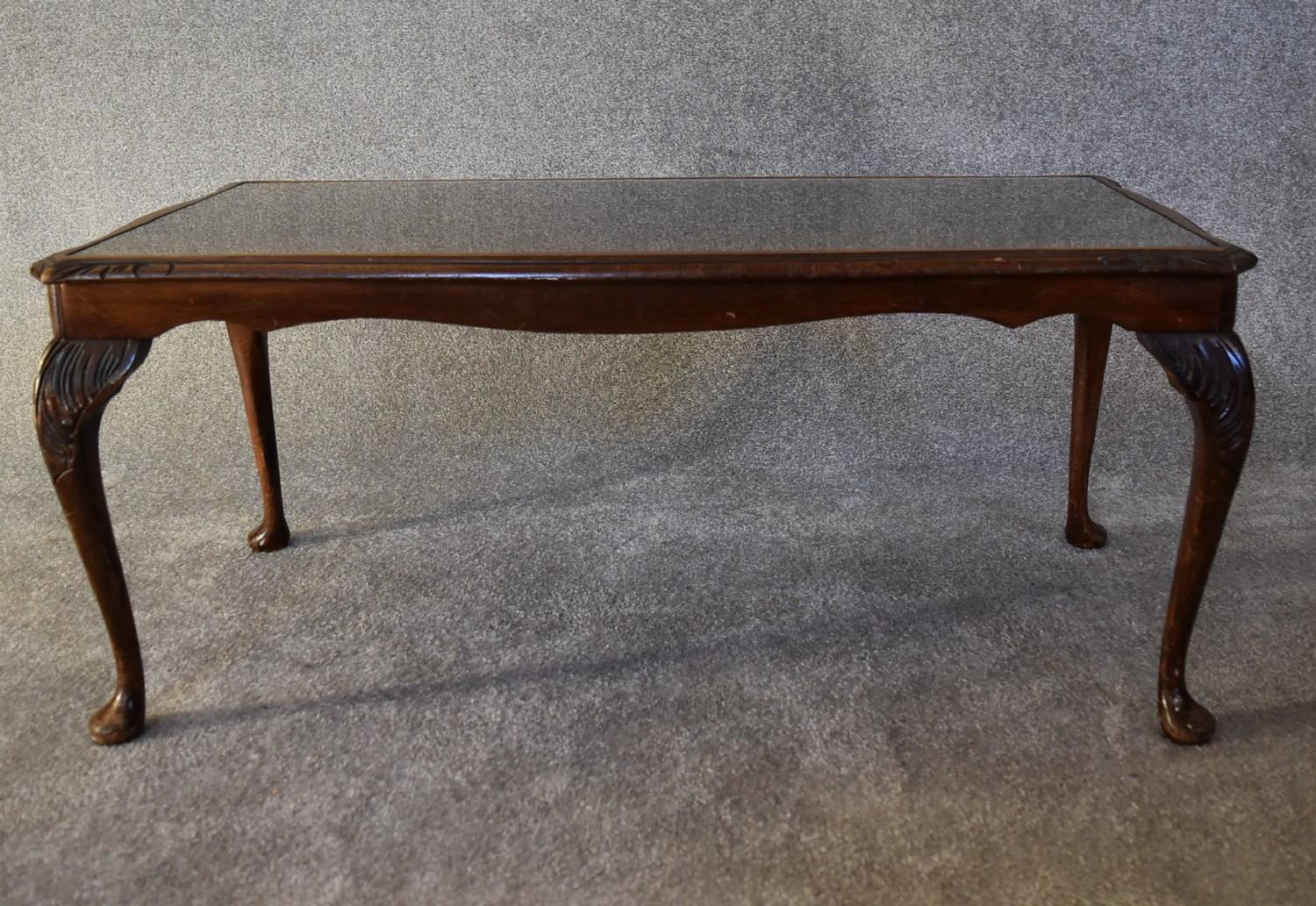 A mahogany Georgian style coffee table with a glass top. H.40 x 97cm