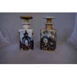 A pair of blue and white French porcelain scent bottles with oriental design and gilded accents.