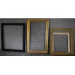 A gilt frame by Brooks, label verso, a carved frame and another. H.129 x 80cm (largest)