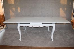 A Louis XV style pale blue distressed painted draw leaf dining table on carved cabriole supports L.