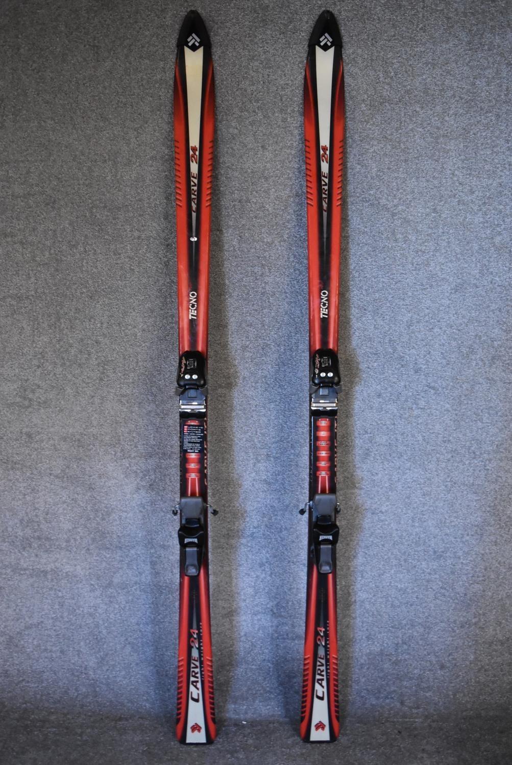 A pair of Tecno Pro lightweight skis, ski sticks and carrying holdall. L.167cm