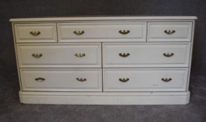 A cream lacquered Victorian style bank of seven drawers. H.70 x 140cm