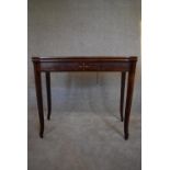 A 19th century mahogany and satinwood inlaid foldover top tea table on sabre supports. H.75 x 90 x