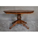 A burr walnut shaped top coffee table on quadruped carved supports. 95cm x 60cm.