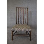 A 19th century country oak spindle back dining chair in tapestry upholstery. H.85 x 50cm