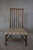 A 19th century country oak spindle back dining chair in tapestry upholstery. H.85 x 50cm