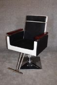 A retro style barber's chair with rise and fall and fully reclining action on chrome base. H.97 x