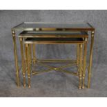 A nest of three graduating brass framed and glass topped occasional tables. H.48 x 60cm