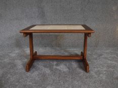 A mid 20th century teak low table with inset floral tiles. H.36 x 42cm