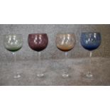 A set of four crystal coloured wine glasses. H.23cm