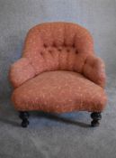 A Victorian mahogany framed button back nursing chair, upholstered in rouge fabric with gold leaf